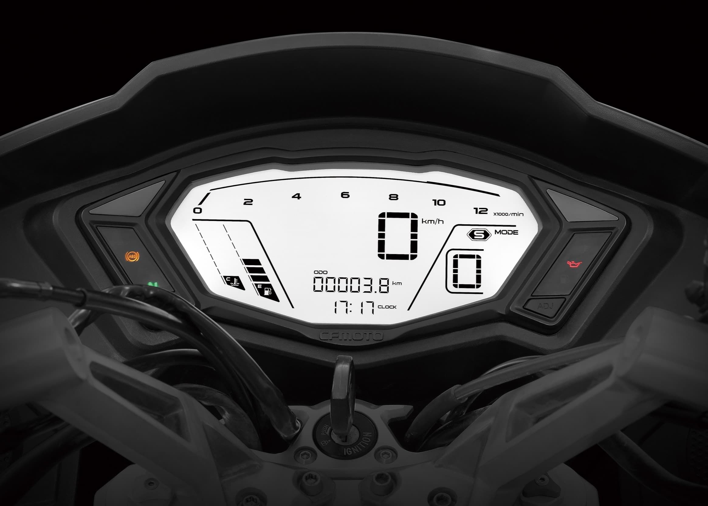 Mounted monochrome LCD showing digital speed, tachometer scale, gear, odometer, clock and gauges; ignition key is visible.